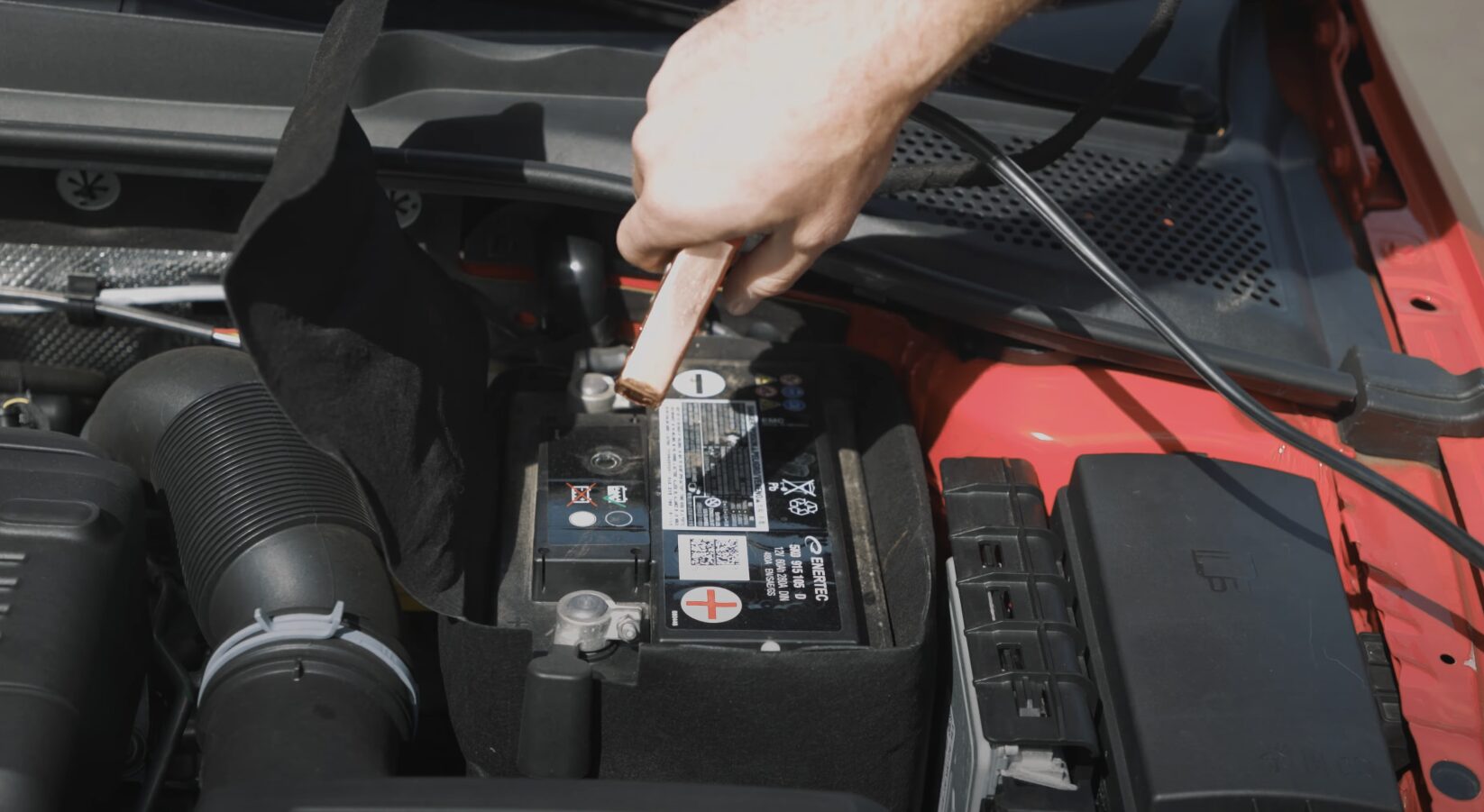Professional roadside assistance helping with car battery issues in Elmhurst IL Roadside assistance services including jump starts and battery replacement
