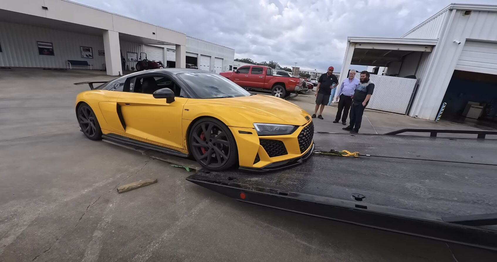 Safe flatbed towing for luxury vehicles - protecting your investment Luxury sports car being safely loaded onto professional flatbed tow truck